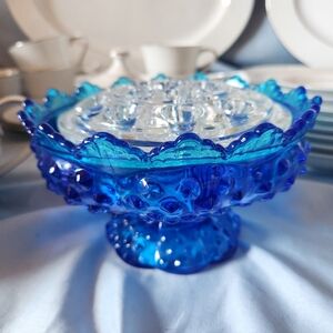 Gorgeous and stunning blue glass Fenton candle bowl holder.
